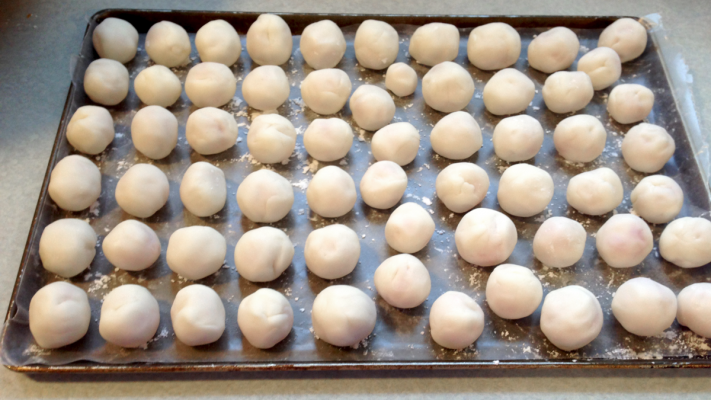 Figure 2. Fondant wrapped cherries on a sheet pan covered with wax paper that is lightly dusted in powdered sugar