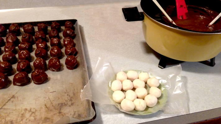 Figure 5. Chocolate covered cherries cooling on a sheet pan covered in wax paper