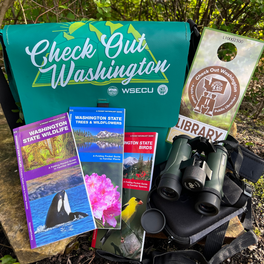 Contents of the Check Out Washington Discover Pass Backpack: Binoculars, a special library Discover Pass, Washington state field guides, and other materials