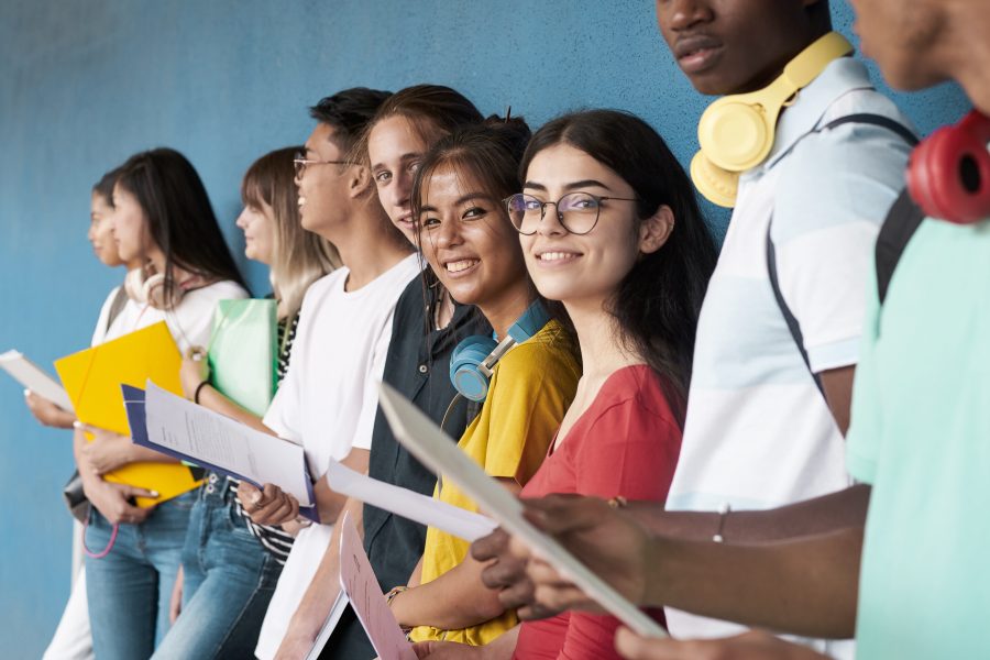 Teens gathered together with flyers in their hands