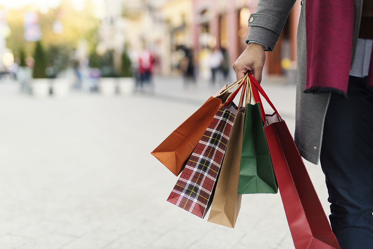 Person holding festive gift bags