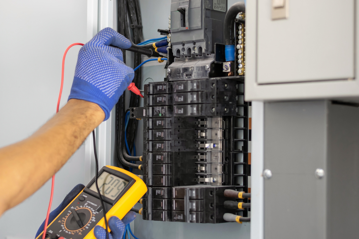 Electrician working on an electrical panel